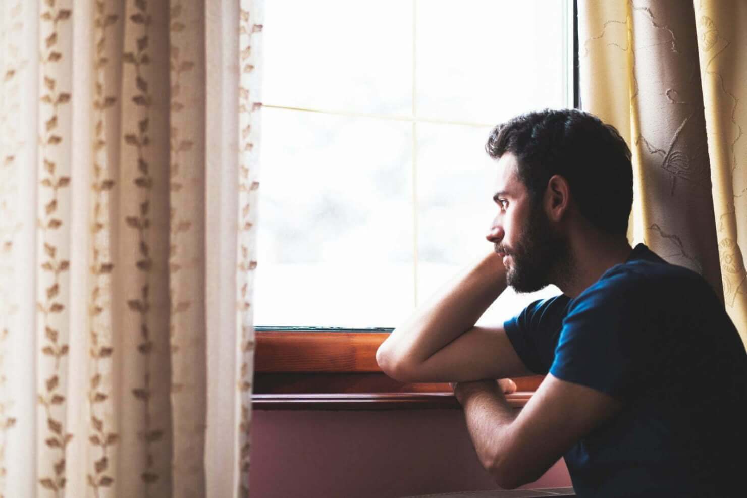 Man sitting looking out a window