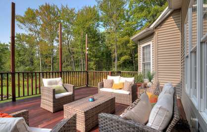 A deck with wicker furniture and a fire pit, perfect for a relaxing outdoor space for inpatient treatment or outpatient program.
