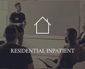 A man is speaking to a group of people, with the words "RESIDENTIAL INPATIENT" overtop of the photo.