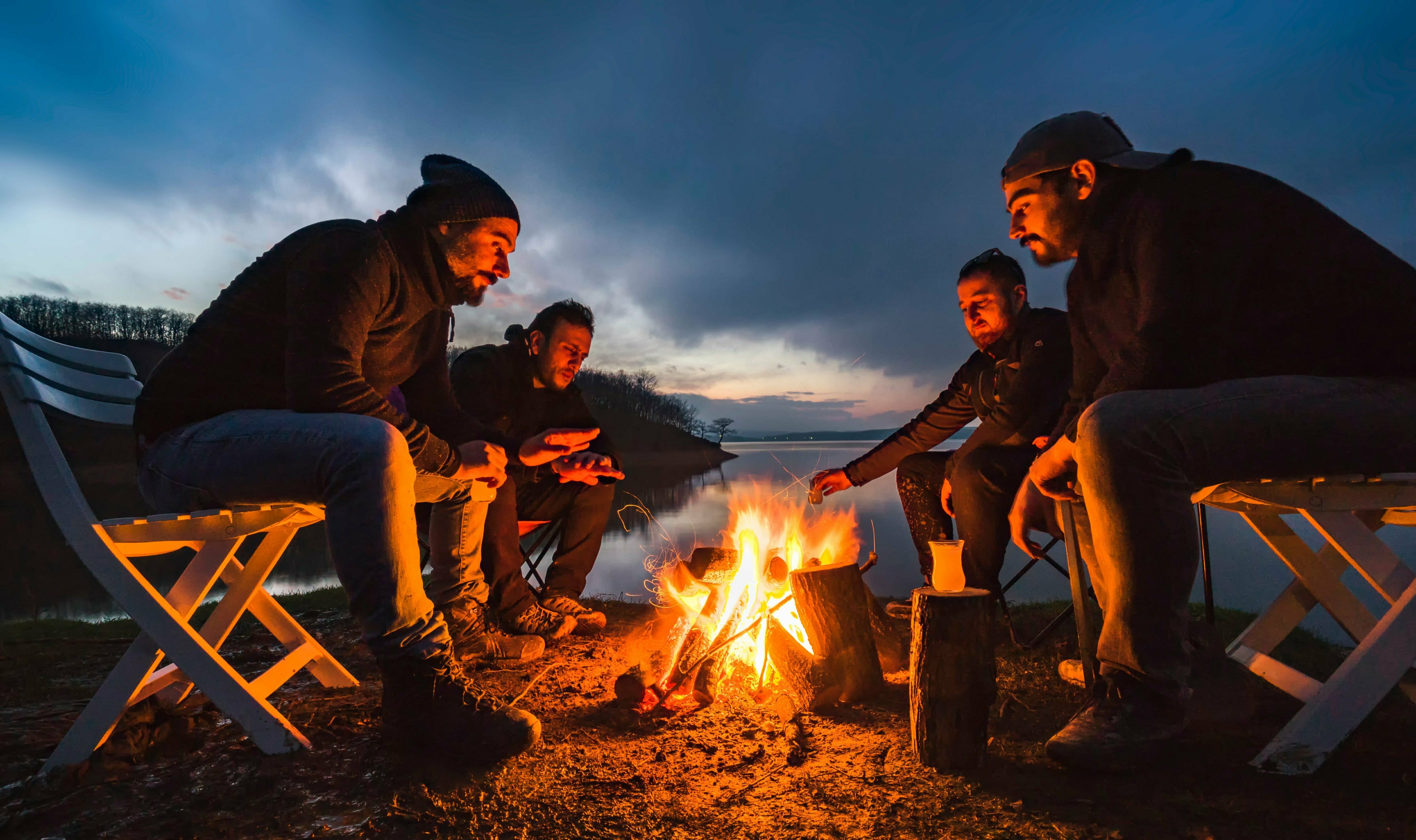 A group of friends sitting around a campfire at an outpatient program.