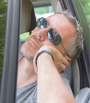 Man asleep in car window