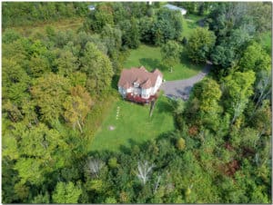 An aerial view of a house surrounded by trees, nestled near an men's only rehab addiction recovery center.