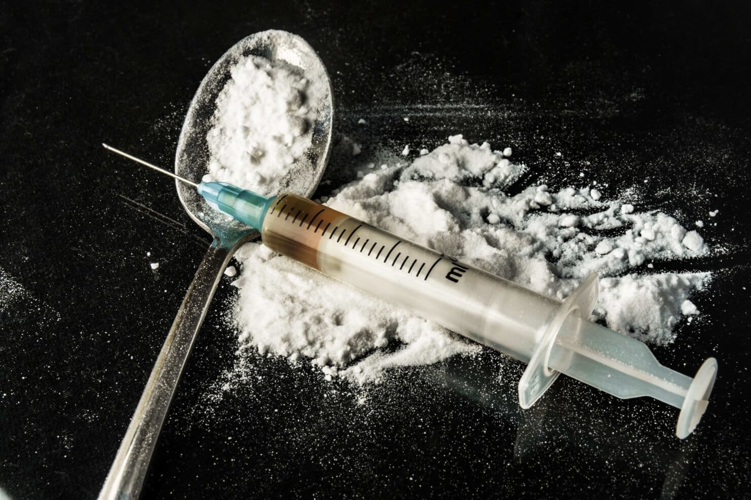 An addiction recovery center providing inpatient treatment with a syringe and powder.