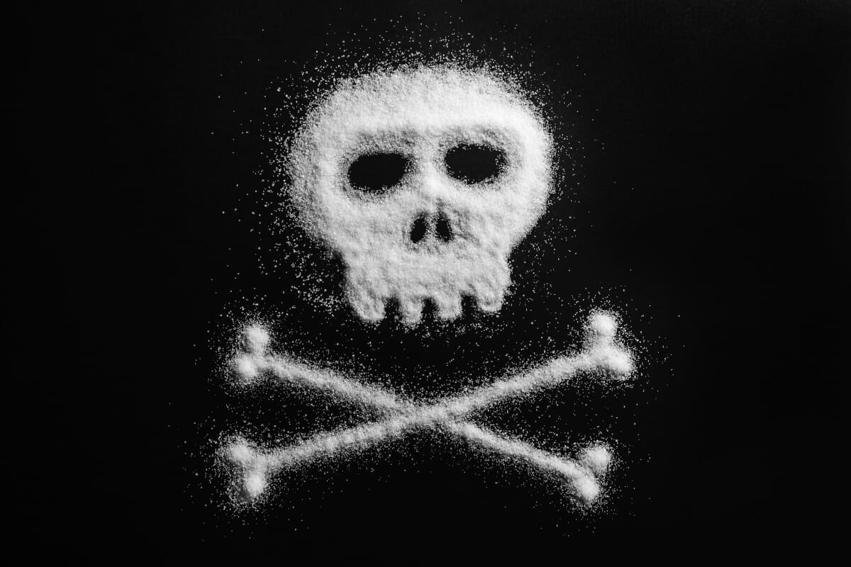 A skull and crossbones made of sugar on a black background symbolizing the dangers of substance abuse prevalent in drug detox centers.