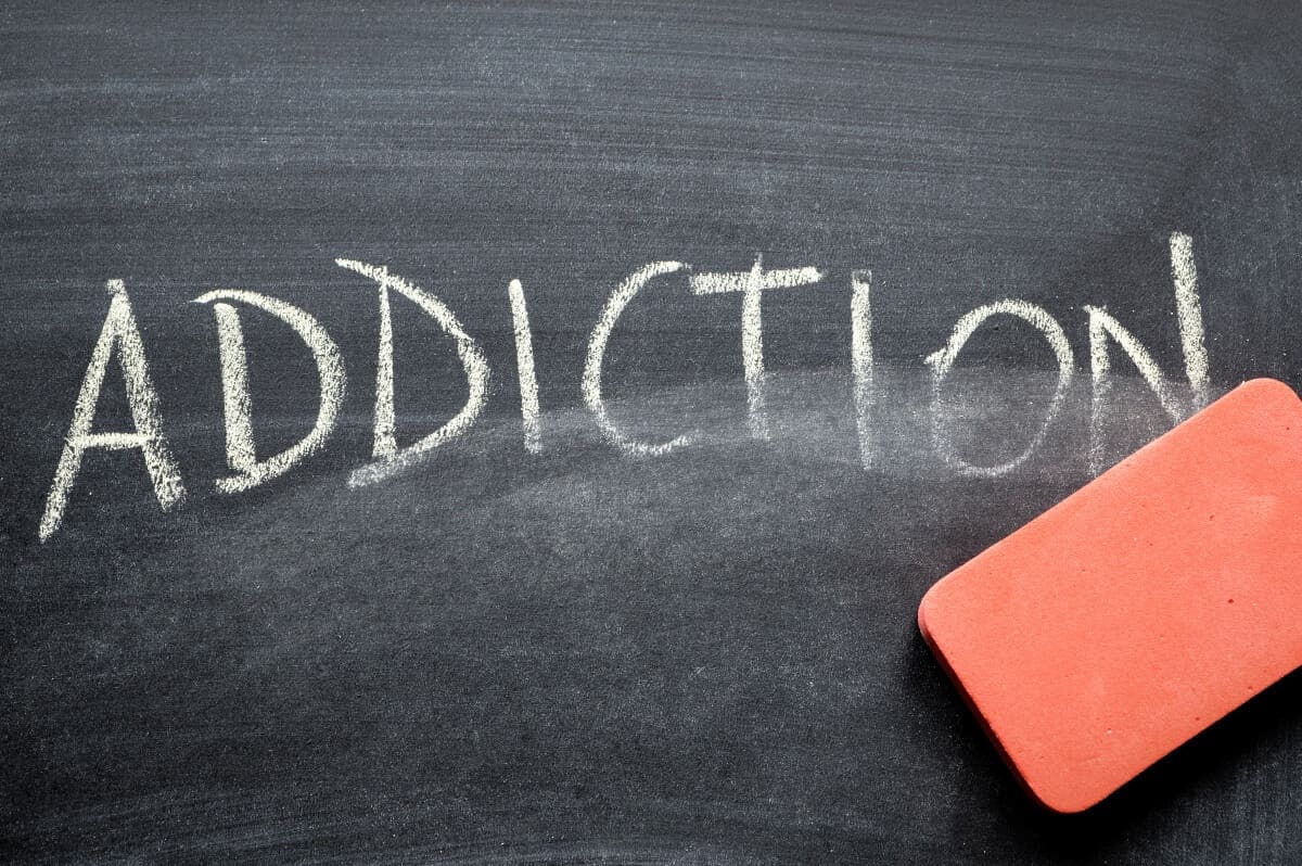 A blackboard with the word addiction written on it, symbolizing the importance of seeking help from a drug detox center or outpatient program.
