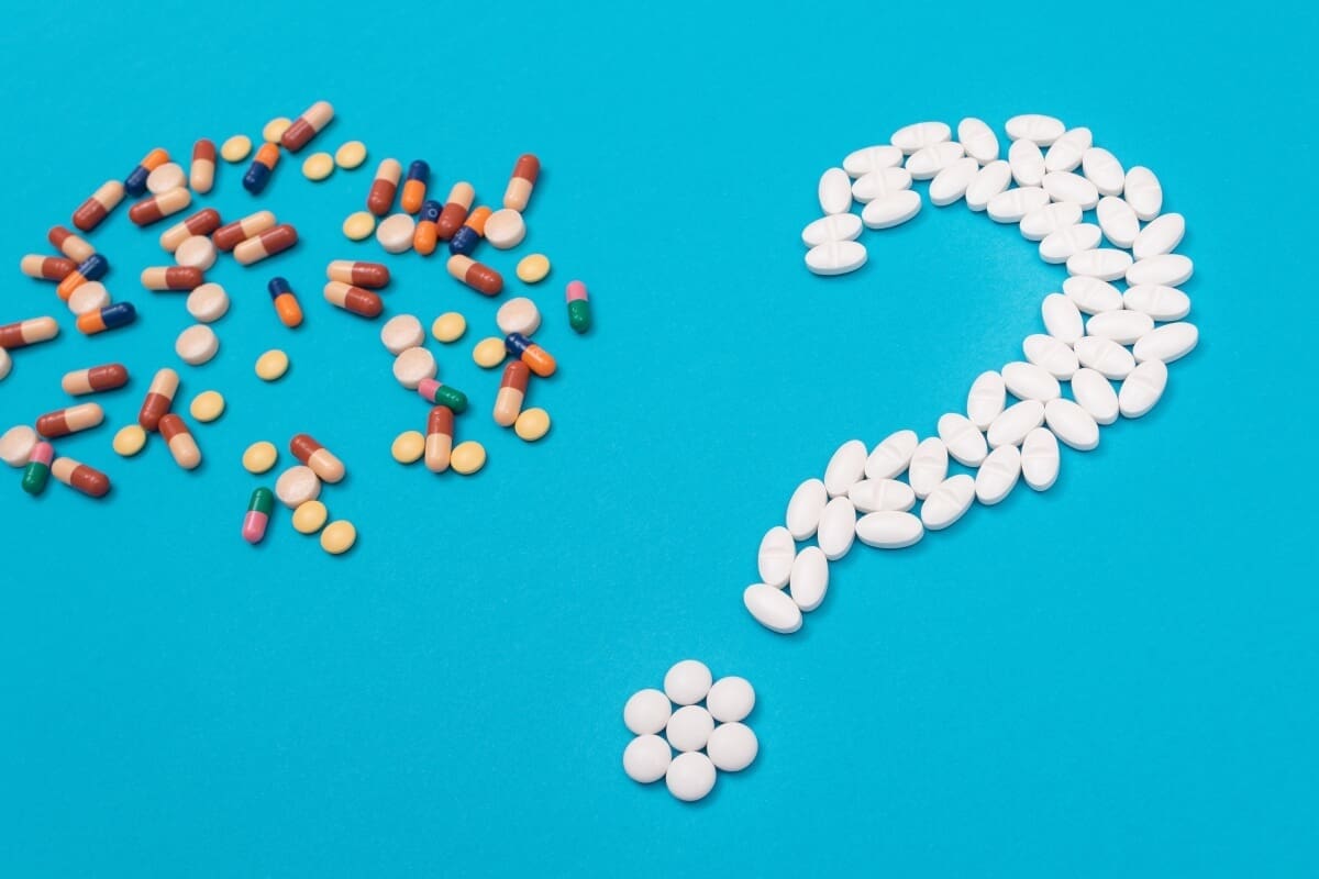 A question mark made of pills.