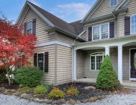 Suburban house in Cleveland, OH with beige siding and autumn foliage.